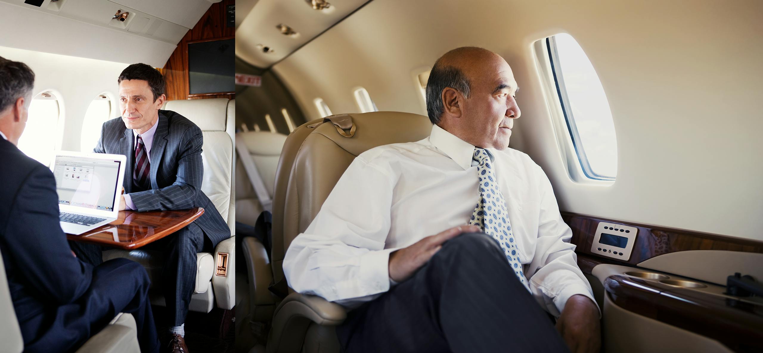 Business men conversing, one executive observing the view